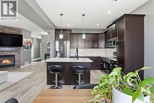 17 600 Maple Crescent, Warman, SK - Indoor Photo Showing Kitchen With Fireplace With Stainless Steel Kitchen With Upgraded Kitchen