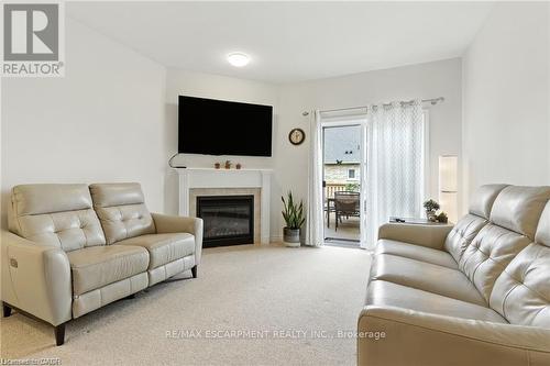 20 - 310 Southbrook Drive, Hamilton, ON - Indoor Photo Showing Living Room With Fireplace
