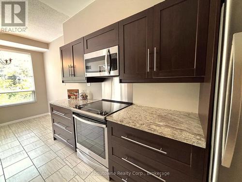 ... with Stainless Steel Appliances - 406 - 2511 Lakeshore Road W, Oakville (Br Bronte), ON - Indoor Photo Showing Kitchen