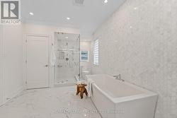 Spectacular, marble-clad five-piece ensuite. - 