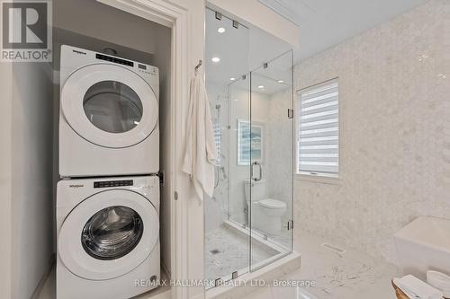 Glass shower and stacked washer and dryer. - 129 High Street W, Mississauga, ON - Indoor Photo Showing Laundry Room