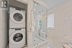 Glass shower and stacked washer and dryer. - 