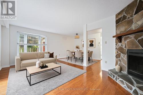 Virtually Staged Living and Dining Areas - 7 - 1241 Mccraney Street E, Oakville, ON - Indoor Photo Showing Living Room With Fireplace