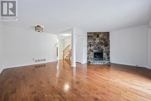 Living Room Features a Woodburning Fireplace - 7 - 1241 Mccraney Street E, Oakville, ON - Indoor Photo Showing Living Room With Fireplace