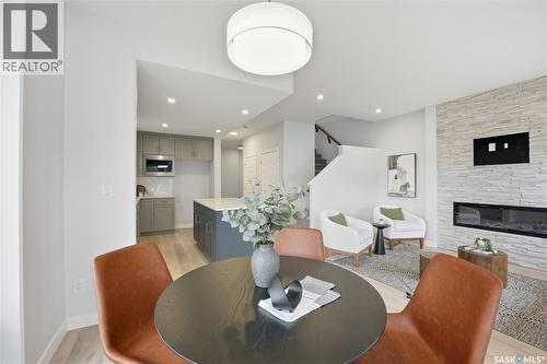 202 Antonini Court, Saskatoon, SK - Indoor Photo Showing Dining Room With Fireplace