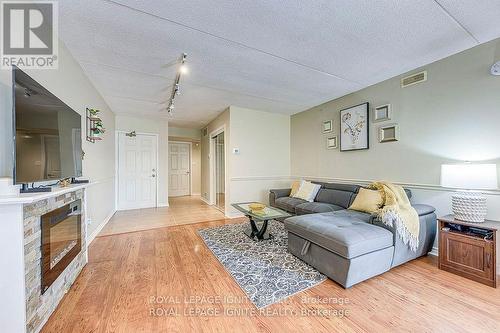 211 - 1820 Walkers Line, Burlington, ON - Indoor Photo Showing Living Room With Fireplace