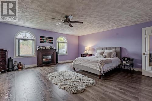 16-22 Bacon Cove Road, Conception Harbour, NL - Indoor Photo Showing Bedroom With Fireplace