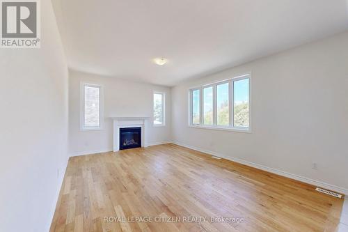 87 Lawrence D. Pridham Avenue, New Tecumseth, ON - Indoor Photo Showing Other Room With Fireplace