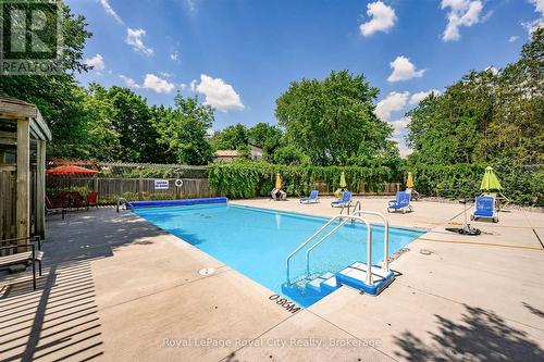 Outdoor heated pool - 403 - 93 Westwood Road, Guelph (Willow West/Sugarbush/West Acres), ON - Outdoor With In Ground Pool With Backyard