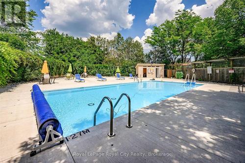outdoor heated pool - 403 - 93 Westwood Road, Guelph (Willow West/Sugarbush/West Acres), ON - Outdoor With In Ground Pool With Backyard
