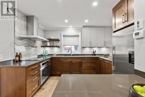 Bespoke cabinets and quartz give a luxurious feel. - 217 Belford Crescent, Ottawa, ON - Indoor Photo Showing Kitchen With Double Sink With Upgraded Kitchen