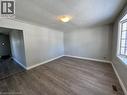 Empty room featuring baseboards and dark wood-type flooring - 121 Roberts Crescent Unit# Upper, Kitchener, ON  - Indoor Photo Showing Other Room 