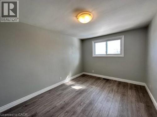 Spare room featuring baseboards and dark wood-style floors - 121 Roberts Crescent Unit# Upper, Kitchener, ON - Indoor Photo Showing Other Room