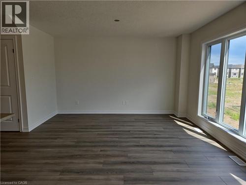 Spare room with dark wood finished floors and a textured ceiling - 261 Benninger Drive Unit# Upper, Kitchener, ON - Indoor Photo Showing Other Room