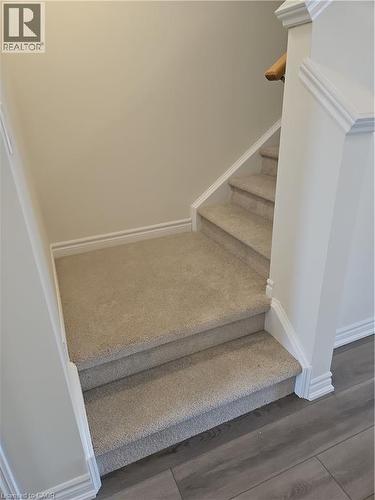 Stairs featuring baseboards and wood finished floors - 261 Benninger Drive Unit# Upper, Kitchener, ON - Indoor Photo Showing Other Room