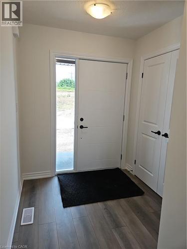 Foyer featuring baseboards and dark wood-type flooring - 261 Benninger Drive Unit# Upper, Kitchener, ON - Indoor Photo Showing Other Room