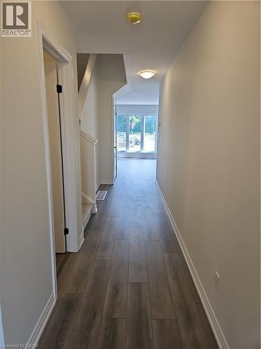 Corridor with baseboards and dark wood-type flooring - 261 Benninger Drive Unit# Upper, Kitchener, ON - Indoor Photo Showing Other Room