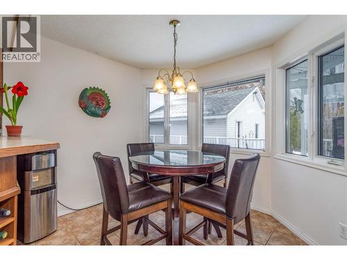 Breakfast nook with bright bay windows. - 1125 Keyes Road, Kelowna, BC - Indoor Photo Showing Dining Room