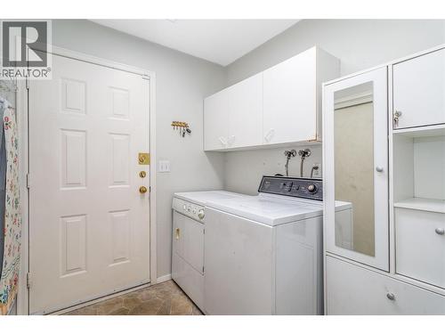 Main floor laundry and access to garage. - 1125 Keyes Road, Kelowna, BC - Indoor Photo Showing Laundry Room