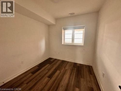 Empty room with dark wood-style floors and baseboards - 205 West Oak Trail Unit# 66, Kitchener, ON - Indoor Photo Showing Other Room