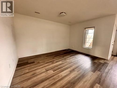 Spare room featuring dark wood-style flooring and baseboards - 205 West Oak Trail Unit# 66, Kitchener, ON - Indoor Photo Showing Other Room