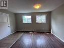 Unfurnished room featuring a textured ceiling, hardwood / wood-style floors, and a baseboard radiator - 17 St Leger Street, Kitchener, ON  - Indoor Photo Showing Other Room 