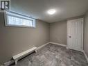 Basement featuring a textured ceiling and baseboard heating - 17 St Leger Street, Kitchener, ON  - Indoor Photo Showing Other Room 