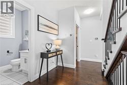 Entrance foyer featuring stairs, a textured ceiling, and dark wood finished floors - 