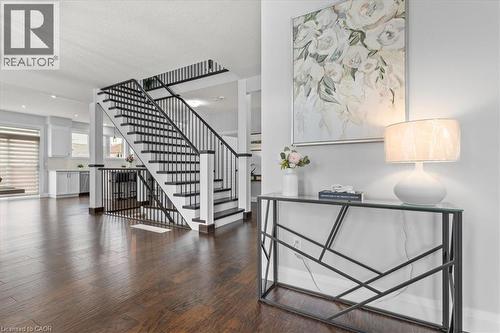 Stairs with wood finished floors and a textured ceiling - 556 Mayapple Street, Waterloo, ON - Indoor Photo Showing Other Room