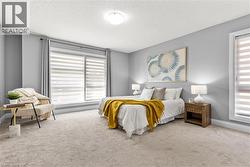 Carpeted bedroom featuring a textured ceiling and multiple windows - 