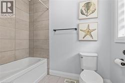 Bathroom with tile patterned flooring and shower / bath combination - 