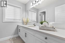 Bathroom featuring vanity and light tile patterned floors - 