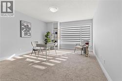 Home office featuring a textured ceiling and light colored carpet - 