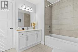 Full bath featuring light tile patterned floors, shower / tub combination, and vanity - 