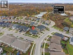 Aerial overview of property's location featuring a large body of water and nearby suburban area - 
