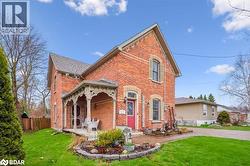 Rear view of property featuring brick siding and a patio area - 