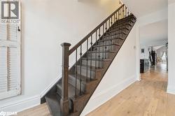 Stairs featuring wood-type flooring and baseboards - 