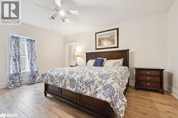 Bedroom with light wood-style flooring and ceiling fan - 