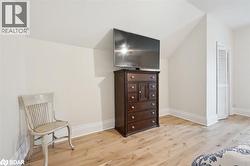 Living area featuring light wood-style floors and baseboards - 