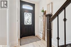 Foyer entrance featuring light wood finished floors and baseboards - 