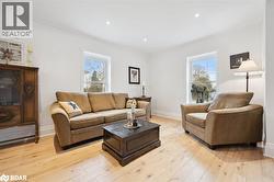 Living area featuring healthy amount of natural light, light wood finished floors, and recessed lighting - 
