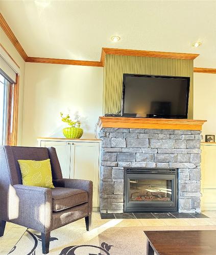 211D-200 Bighorn Boulevard, Radium Hot Springs, BC - Indoor Photo Showing Living Room With Fireplace
