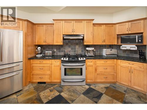 Stainless steel appliances and wood cabinetry - 3356 Merlot Court, West Kelowna, BC - Indoor Photo Showing Kitchen
