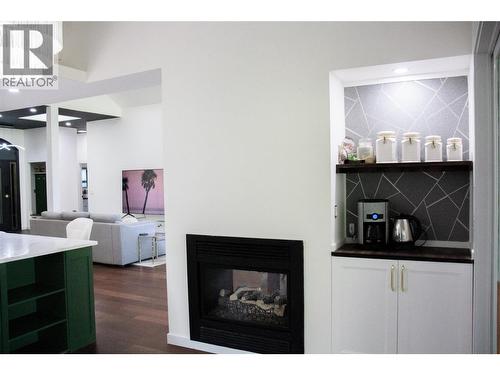 dedicated coffee bar with water line - 3897 Gallaghers Grange, Kelowna, BC - Indoor Photo Showing Other Room With Fireplace