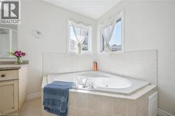 Bathroom with a shower stall, a whirlpool tub, and vanity - 