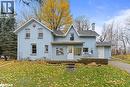 View of front of property featuring a chimney, a front yard, and stucco siding - 9328 Wellinton Road 50, Erin, ON  - Outdoor With Facade 