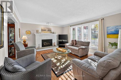 Let the light shine in! - 10 - 2720 Mewburn Road, Niagara Falls (Casey), ON - Indoor Photo Showing Living Room With Fireplace