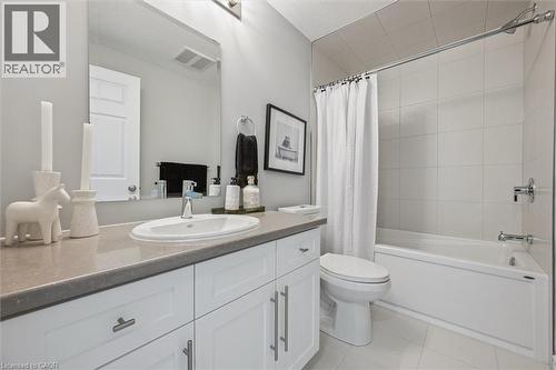 Full bathroom featuring vanity, shower / tub combo with curtain, and light tile patterned flooring - 30 Oat Lane, Kitchener, ON - Indoor Photo Showing Bathroom