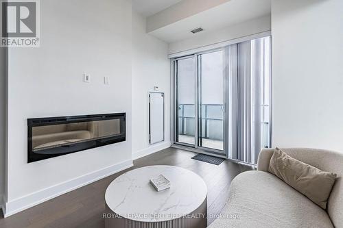 4701 - 20 Shore Breeze Drive, Toronto, ON - Indoor Photo Showing Living Room With Fireplace