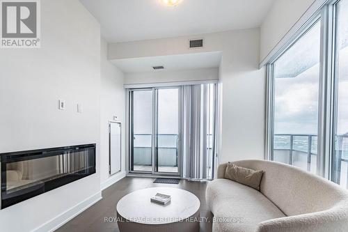 4701 - 20 Shore Breeze Drive, Toronto, ON - Indoor Photo Showing Living Room With Fireplace